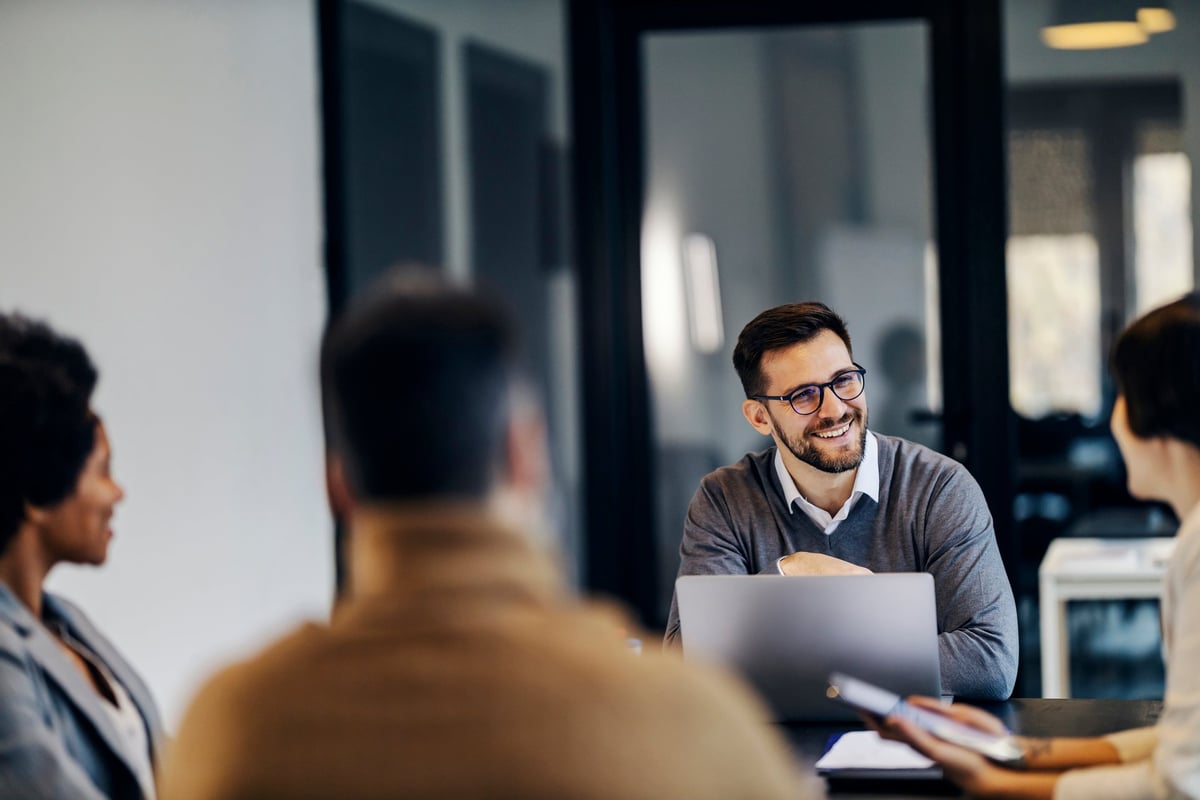 Manager sitting in a co working space with colleagues during a business meeting, choosing a digital marketing agency