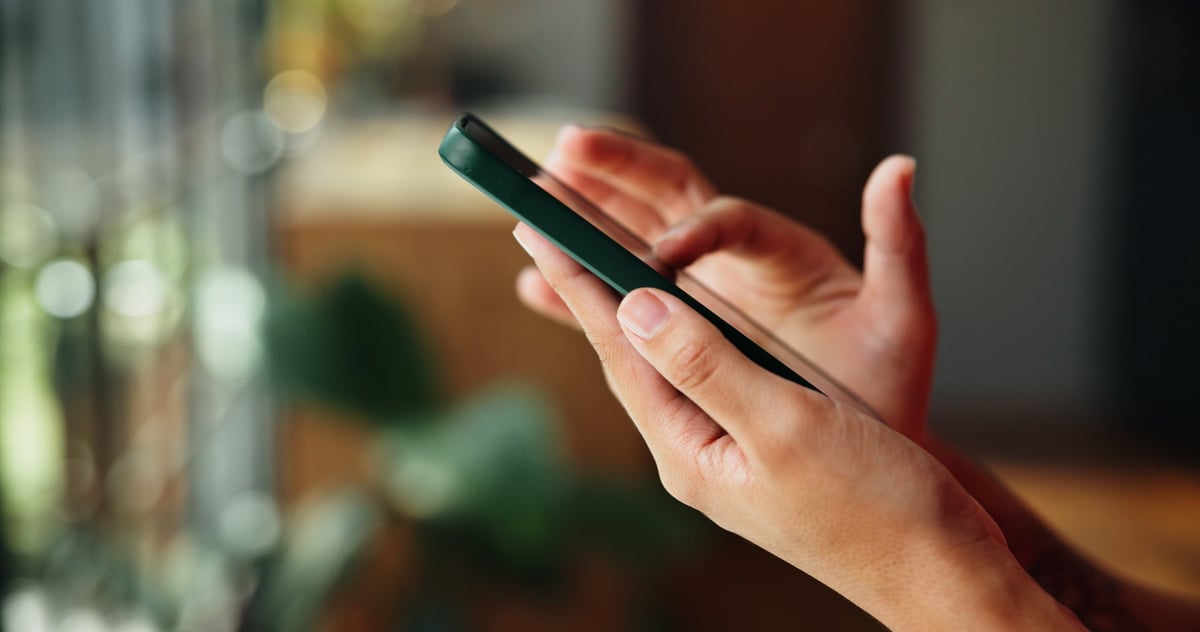 Person scrolling Facebook and Instagram on a phone, where Meta ads reach Australian audiences.