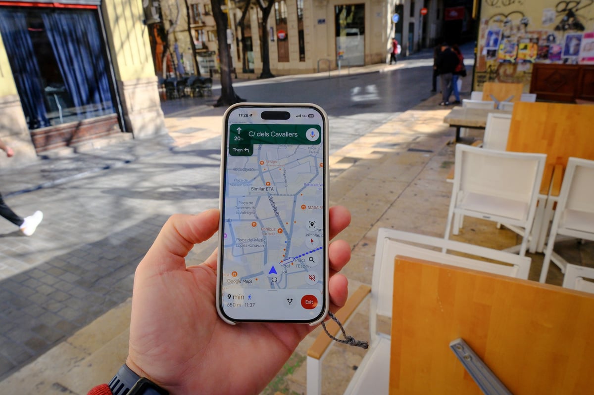 Person following map navigation on a mobile phone while walking through a town, representing local SEO for Adelaide businesses