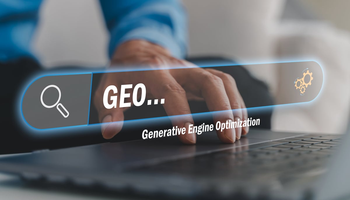 Businessman typing on a laptop keyboard beside a search bar, comparing SEO and Google Ads for a marketing budget
