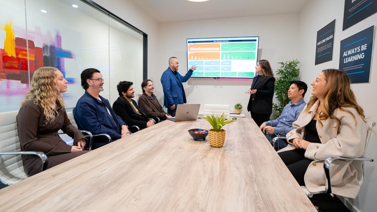 Business owner comparing digital marketing agencies during a meeting.